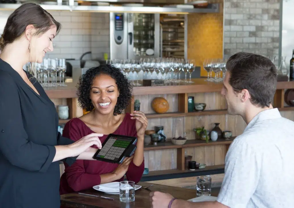 Server using CAKE tableside tablet to take order